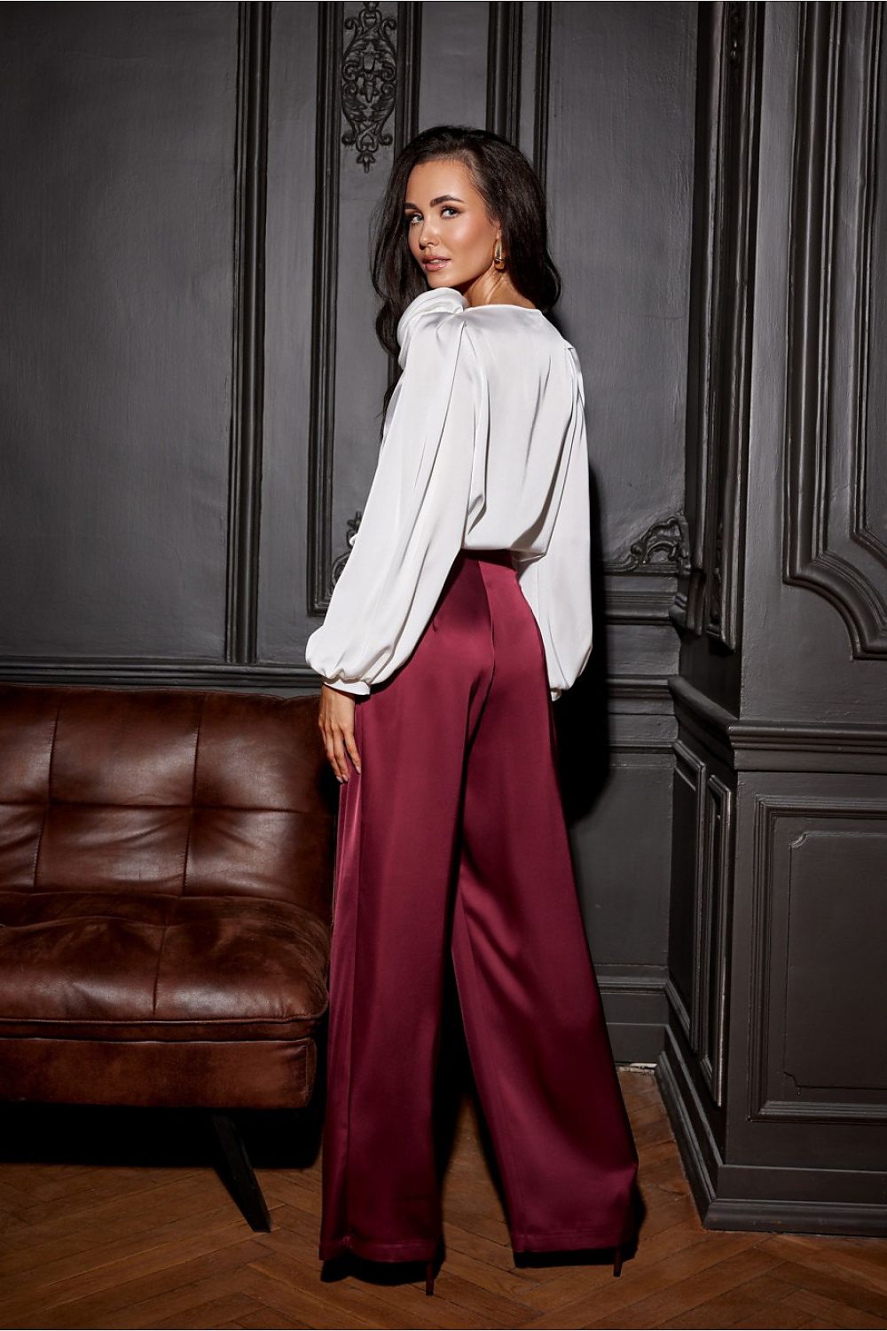 The Evelyn Satin Blouse With Rose Detail from Roco Fashion, elegantly styled with a midi skirt for festive occasions.