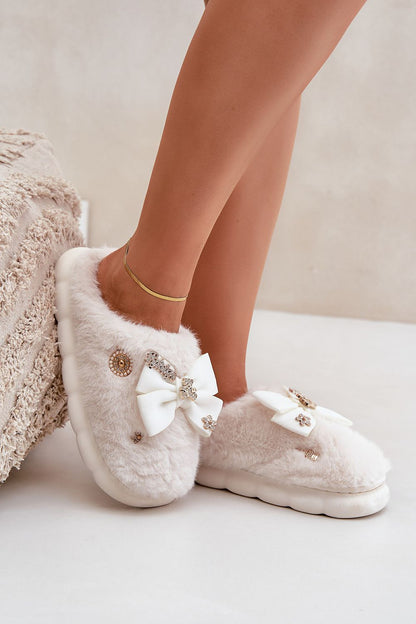 Chic Luxurious Furry Slippers from Step in Style, crafted for warmth with delicate buttons and a stylish bow, ideal for luxe home lounging.