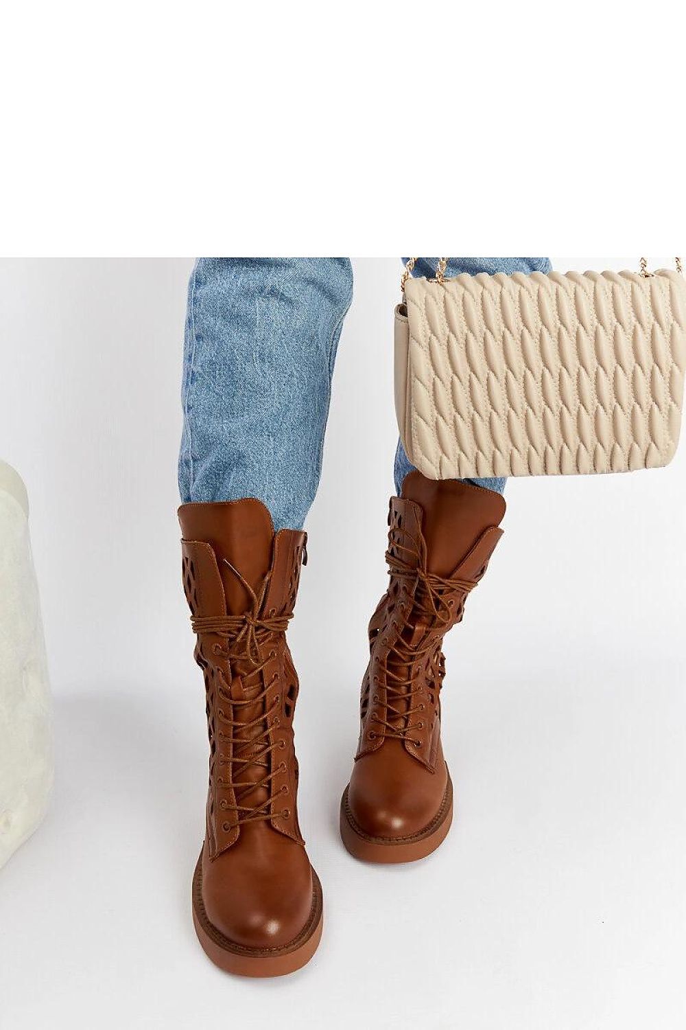 Close-up of Solea's exquisite brown lacy ankle boots with eco leather finish, showcasing the detailed lacing and stylish zipper for easy wear.