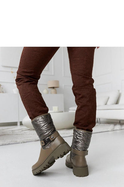 Solea Green Insulated Lido Ankle Boots showcasing their stylish comfort and modern design, perfect for cold weather elegance and adorned with a decorative strap.