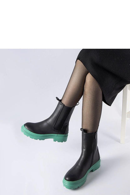 Solea black vegan leather ankle boots elegantly styled with a dress, perfect for autumn-winter fashion.