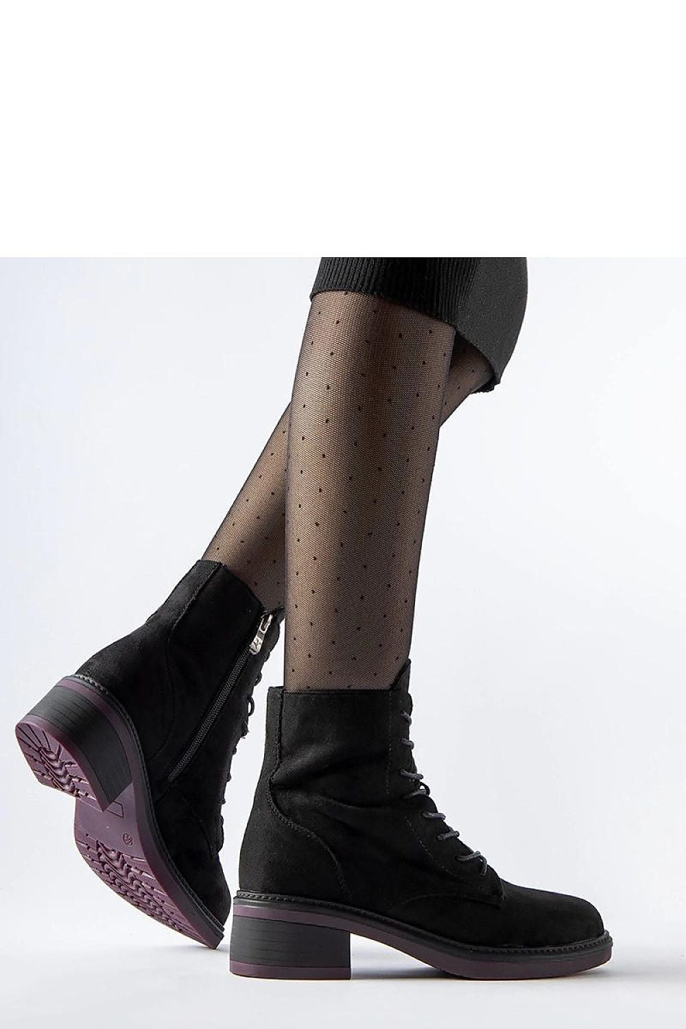 Close-up of Solea black ankle boots showcasing the high-quality synthetic leather exterior, stylish purple sole, and convenient zip closure for chic winter footwear.