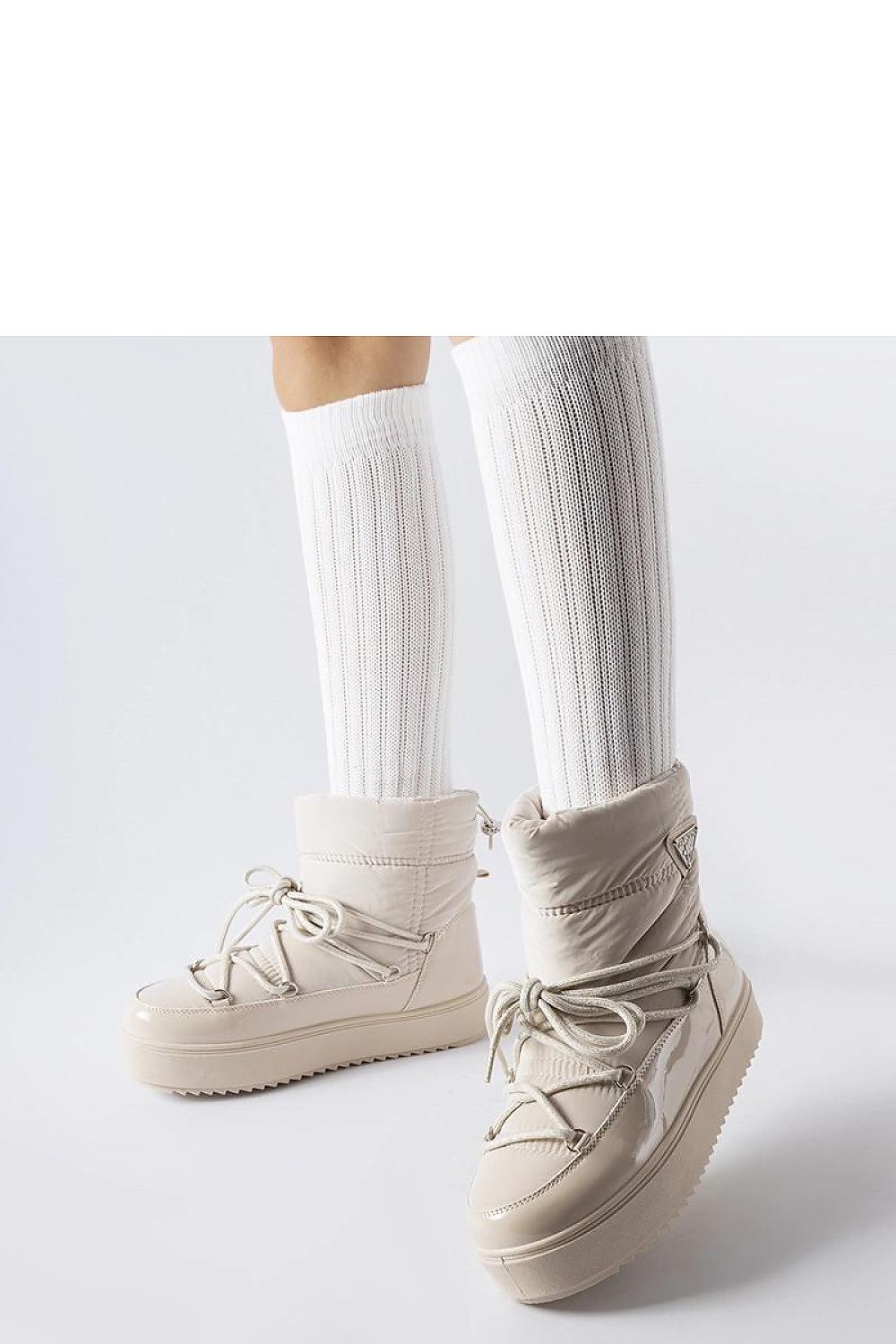 Close-up of Solea's fashionable beige insulated snow boots showcasing the durable rubber exterior and cozy interior, perfect for cold weather.