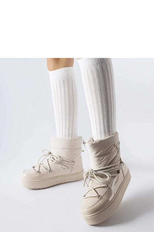 Close-up of Solea's fashionable beige insulated snow boots showcasing the durable rubber exterior and cozy interior, perfect for cold weather.