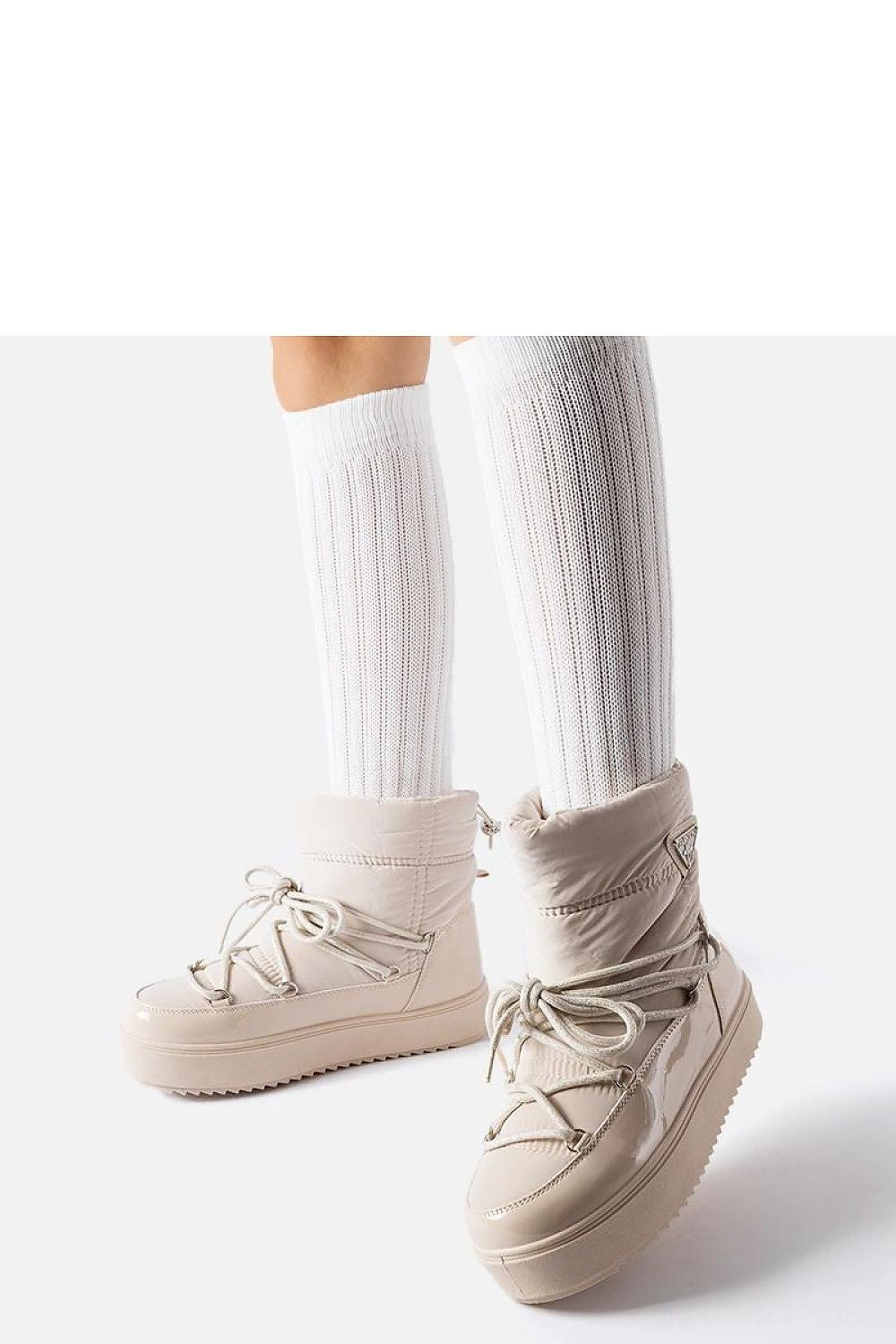 Solea luxury beige insulated snow boots displayed against a winter backdrop, highlighting their innovative platform system and higher ankle for added warmth.