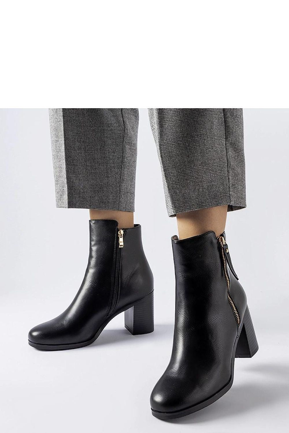 Close-up of Solea Edilio black insulated ankle boots featuring a sleek zipper and feminine almond toe, perfect for cooler weather.