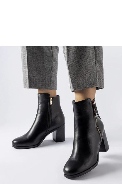 Close-up of Solea Edilio black insulated ankle boots featuring a sleek zipper and feminine almond toe, perfect for cooler weather.