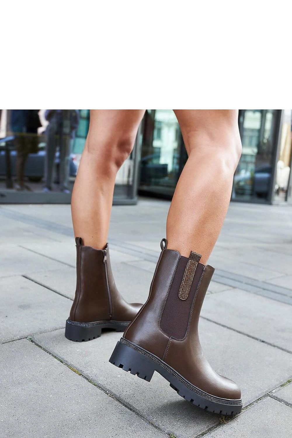 Solea's stylish brown high boots with zircon decorations, perfect for winter, offering comfort and warmth with a flat heel and ankle height, stylish enough for various occasions.