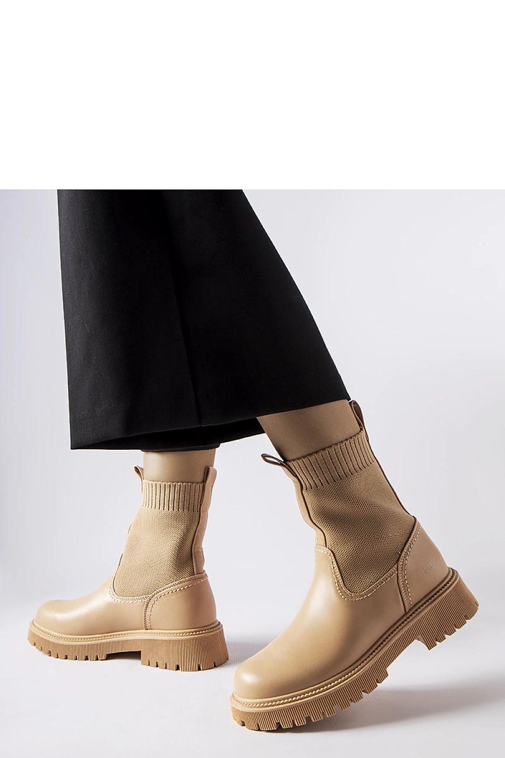 Solea's sophisticated beige eco-suede ankle boots with a round toe design and medium heel, ideal for elevating both casual and formal outfits.