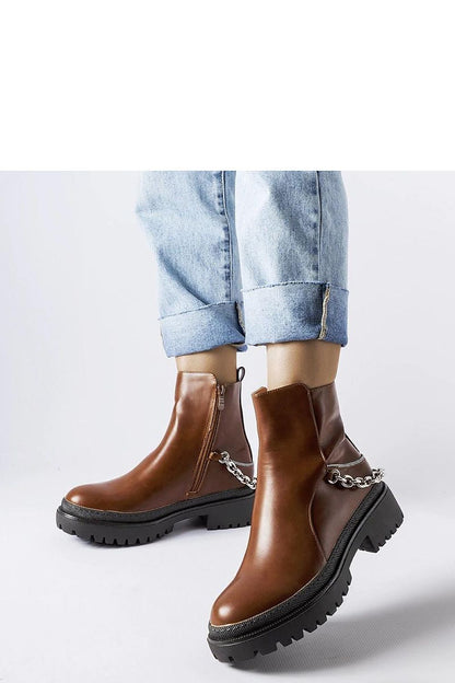 Elegant brown ankle boots by Solea, featuring distinctive chain decoration and round toe design, ideal for winter fashion.