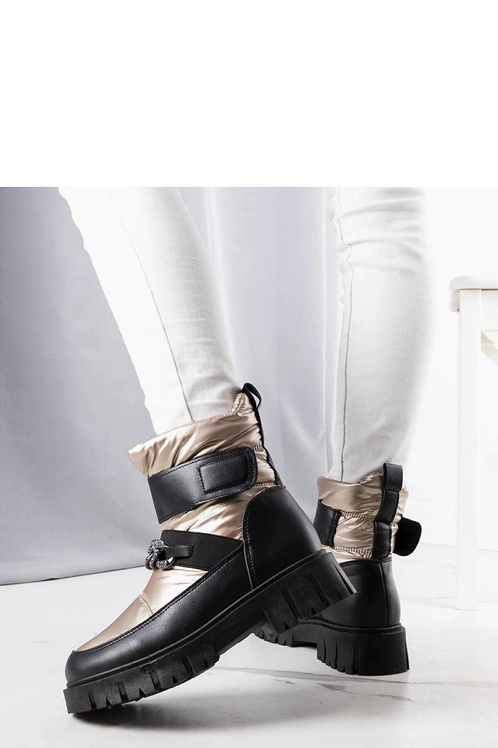 Elegant Solea Golden Snow Boots displayed outdoors, highlighting the chic chain detail and perfect fit for EU sizes 36-41.