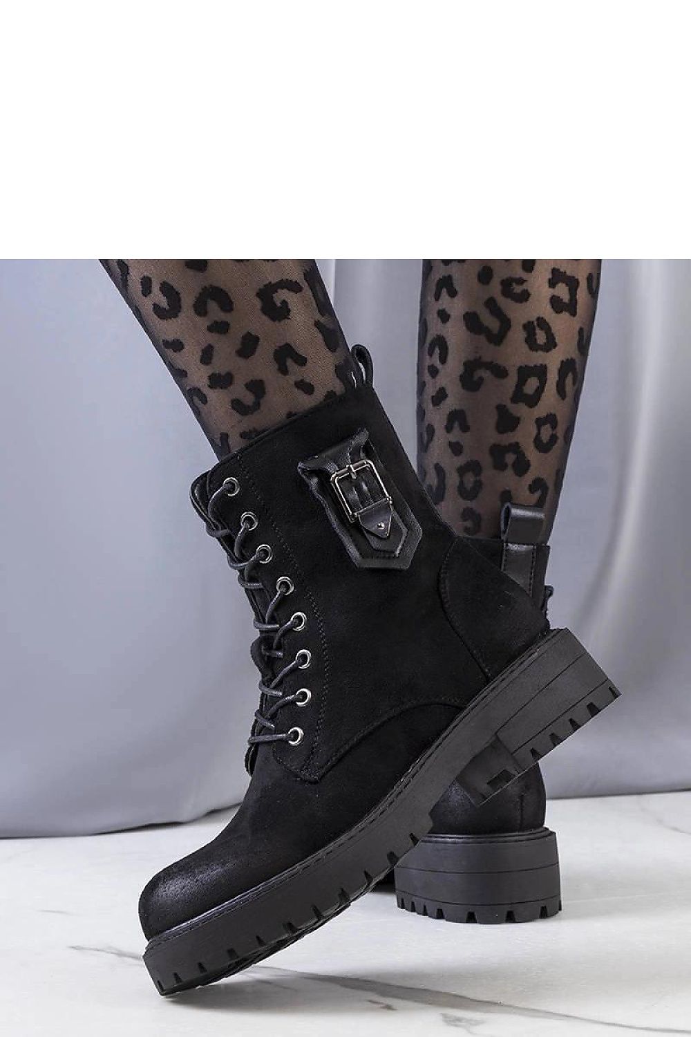 Chic Solea black Judy ankle boots displayed elegantly, showcasing their rubber sole and fashionable design, perfect for autumn and winter.