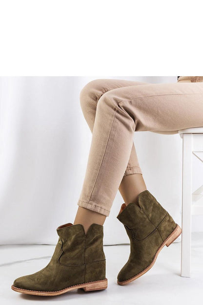 Elegant green ankle boots by Solea featuring a covered wedge, perfect for stylish and comfortable wear on cooler days.