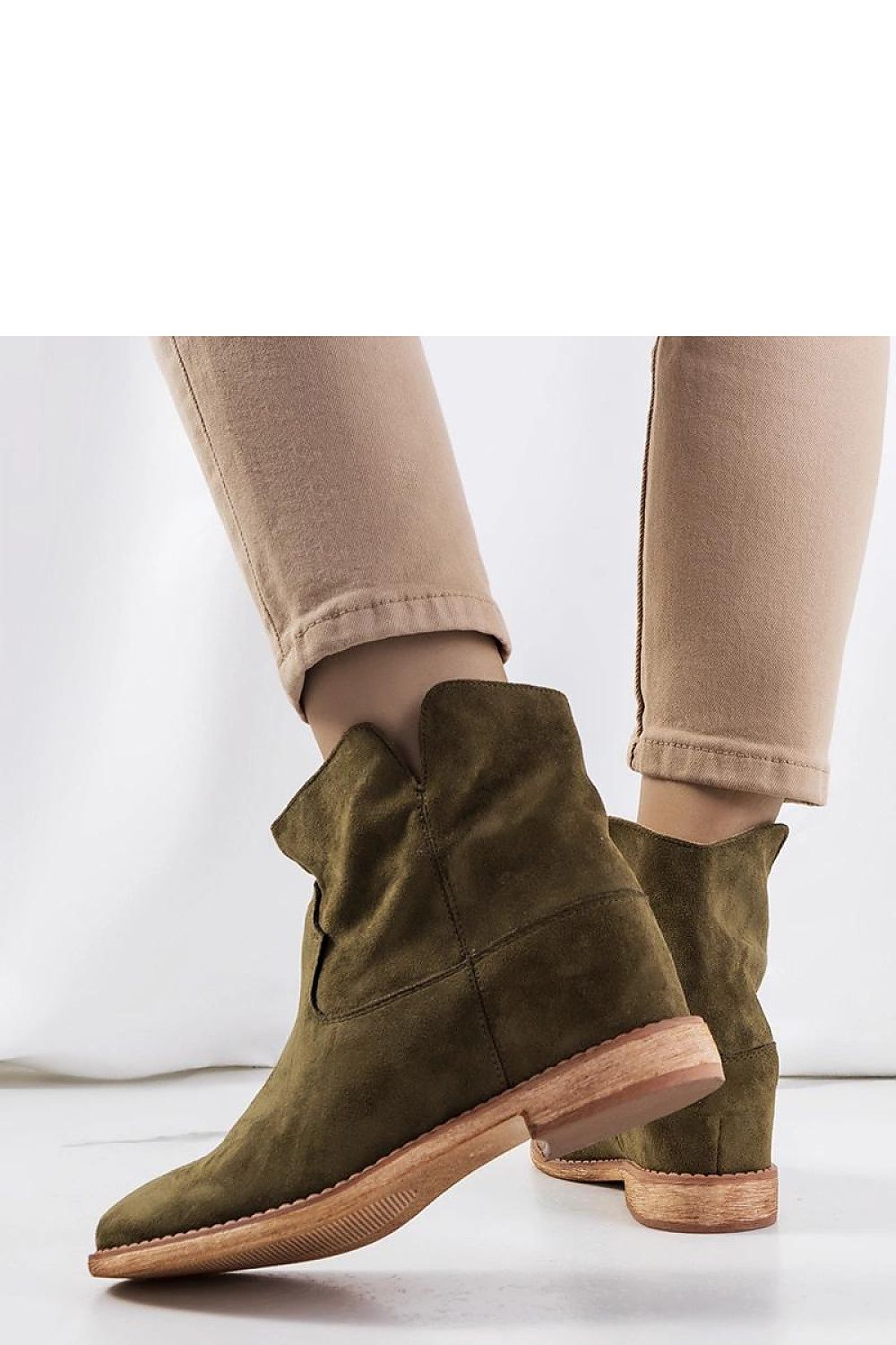 Comfortable and stylish green ankle boots by Solea, showcasing a covered wedge and designed for versatility in EU sizes 36-41.