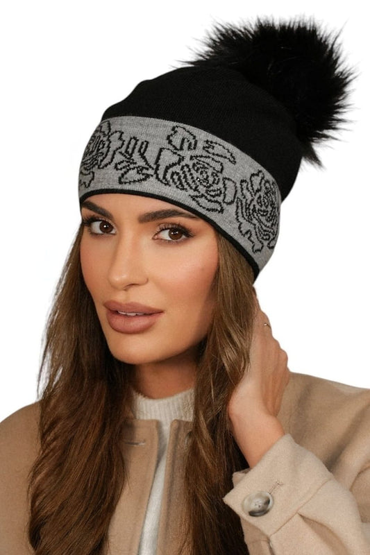 Close-up of Kamea's exquisite beige women's hat featuring a plush faux fur pom-pom, highlighting its soft texture and chic design for upscale winter wear.