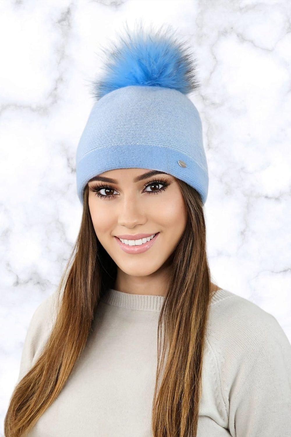 Kamea ALOES warm winter women's hat in blue featuring a stylish houndstooth pattern and an elegant pom-pom, perfect for luxury winter fashion.
