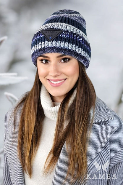 Model wearing Kamea Muscari striped winter hat in raspberry, embodying chic winter elegance and comfort.