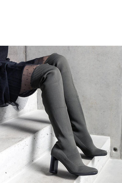 Stylish green stiletto heel boots for women from Solea, featuring an elastic upper and classic almond toe for a sophisticated look.