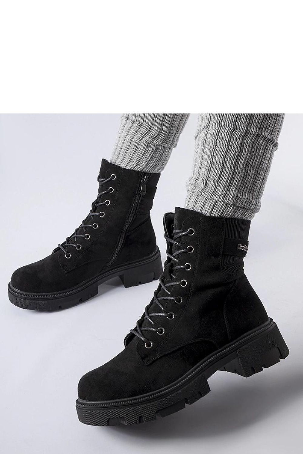 Detailed view of Solea's Black Eco-Suede Cunha Boots highlighting the quality eco-leather fabric, flat heel design for comfort, and stylish lacing suitable for various sophisticated outfits.