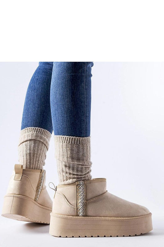 Stylish Solea Beige Dennison Platform Snow Boots with a medium heel and slip-on design, ideal for both casual outings and ski trips during fall and winter.