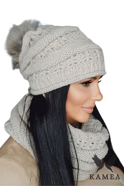 Kamea Premium Liana Women's Winter Hat styled with a large fluffy pompom, highlighting its chic heather texture, perfect accessory for stylish winter outfits.