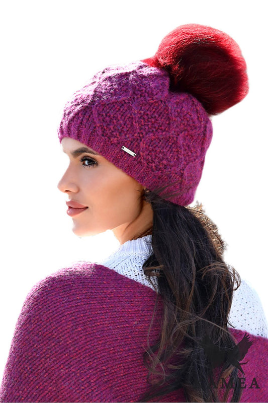 Close-up of the luxurious Kamea Premium Frezja Natural Pompom Hat, featuring a large natural pompon and intricate stitching that adds sophistication to any winter outfit.