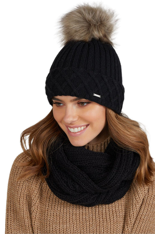 Premium women's Messina winter hat from Kamea featuring a luxuriously soft wool-acrylic blend, elegant pompom detail, and distinctive rolled edge design in a stylish winter outfit.
