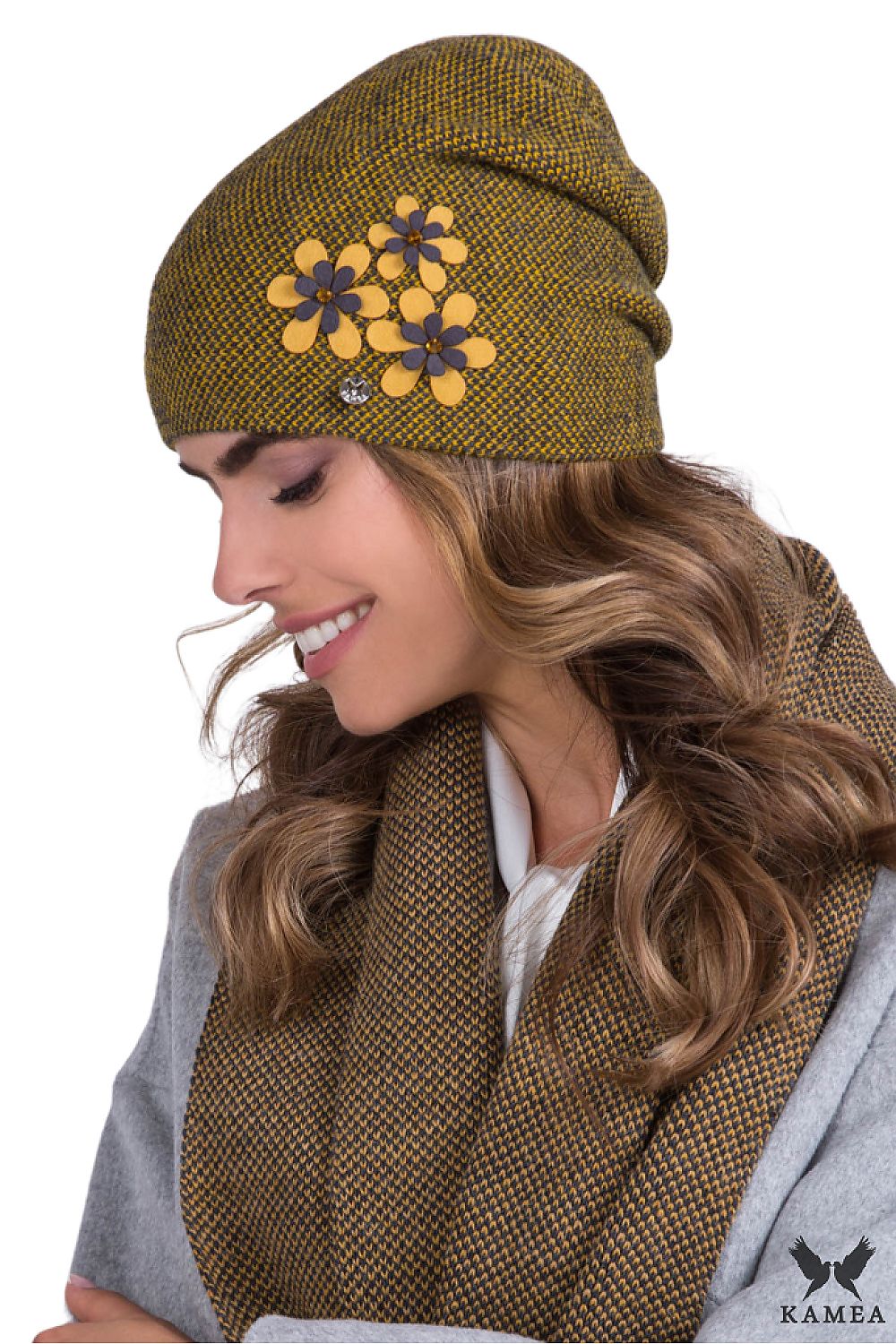 Kamea Premium mustard women's hat featuring elegant houndstooth pattern and vibrant floral applications, adorned with pearls and a silver logo, blending luxury and style in a unique design.