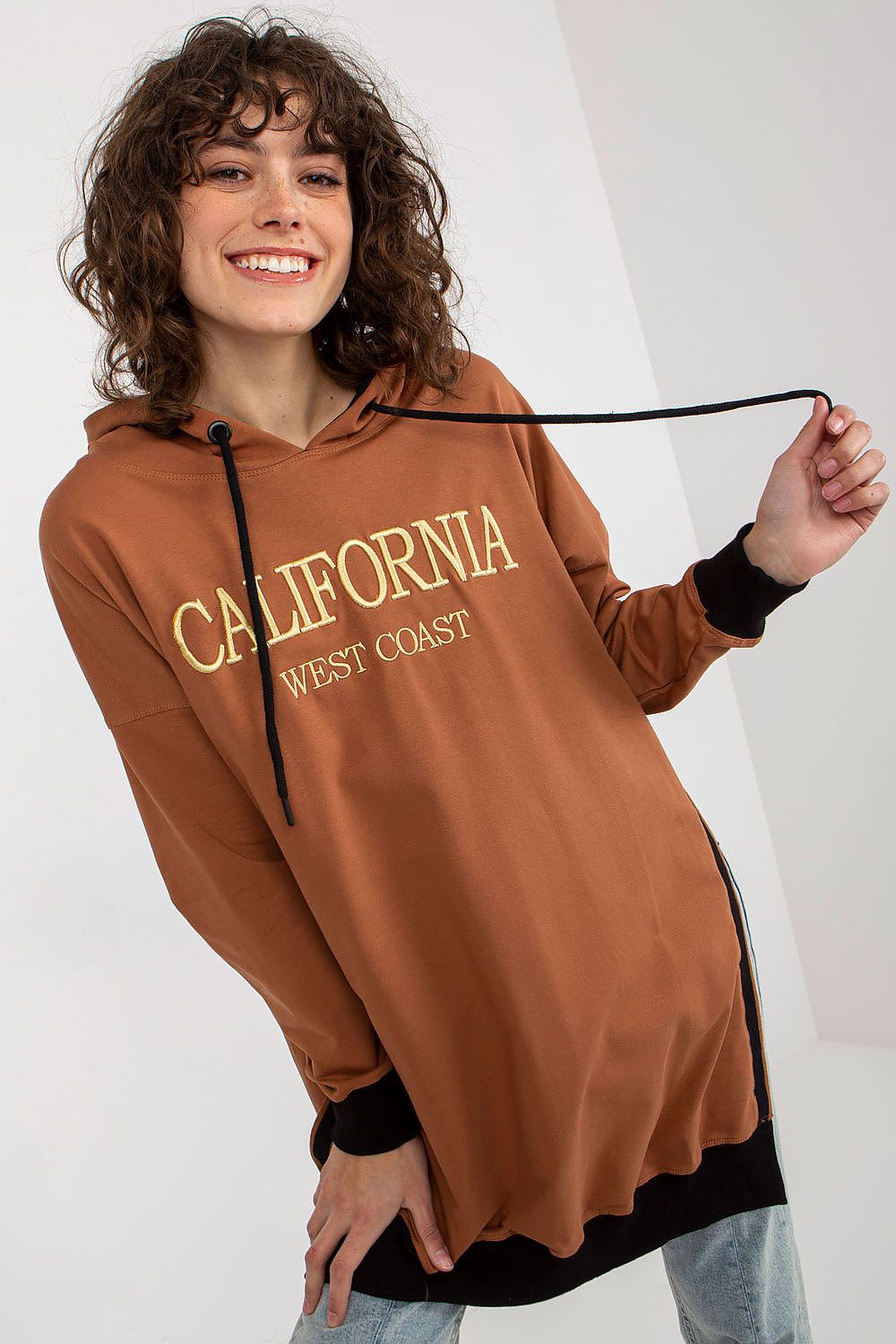 Stylish side view of a women's long casual sweatshirt with a practical hood and drawstrings, available from Factory Price, perfect for modern everyday wear.