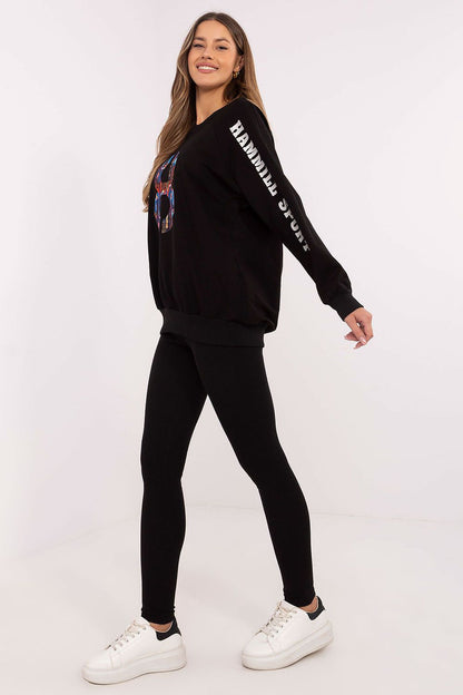 Lifestyle shot of women wearing Factory Price's luxurious sweatshirt and leggings set, embracing elegance and casual style.