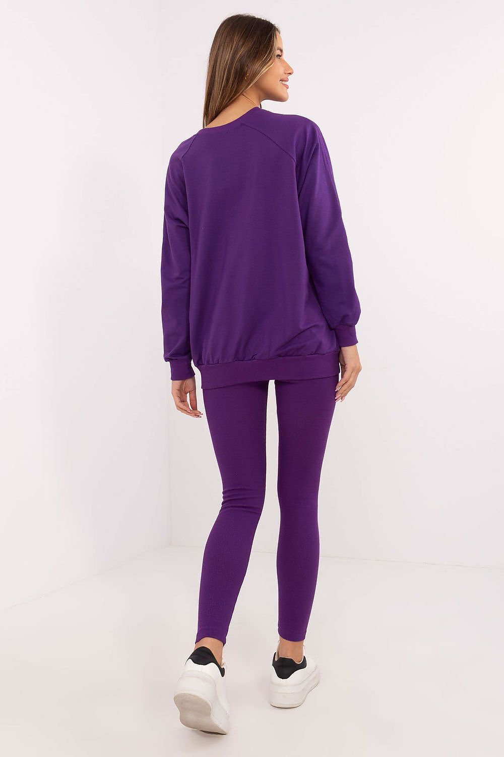 Lifestyle image of a woman wearing the luxury women's sweatshirt and leggings set by Factory Price, epitomizing casual elegance and daily comfort.