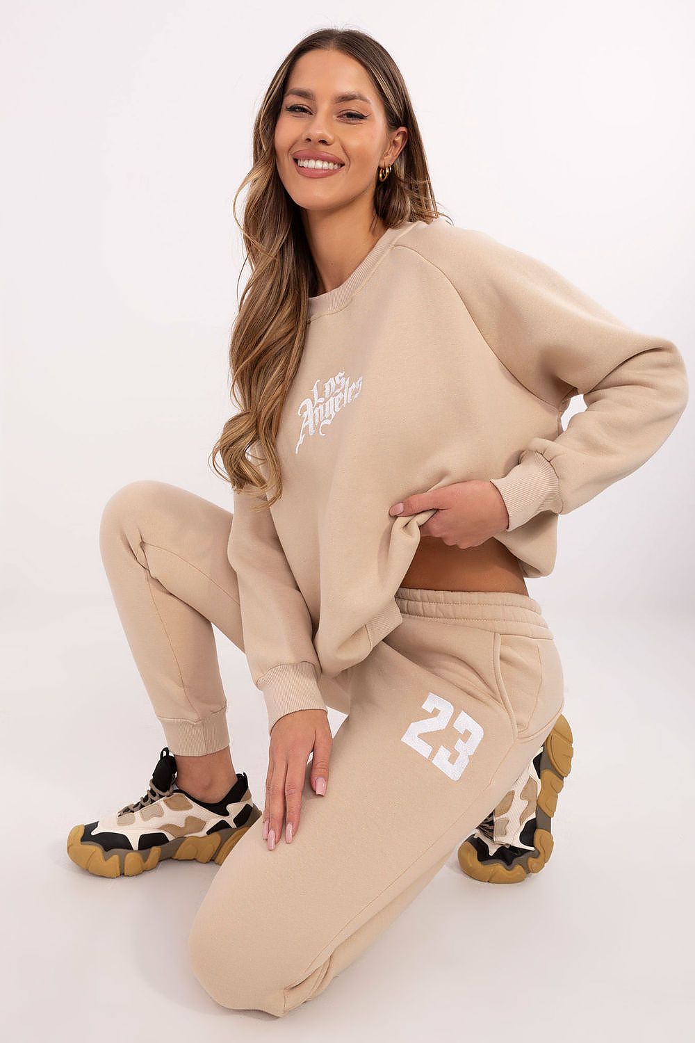Elegant luxury women's tracksuit set with a classic sweatshirt adorned with embroidered designs and high waist pants, designed by Factory Price for ultimate comfort and style.