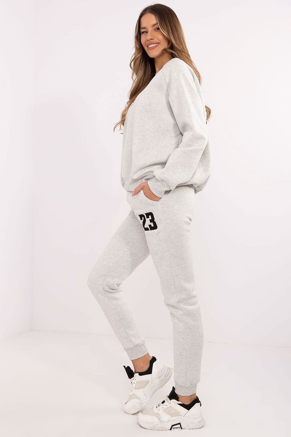 High waist pants of the luxury women's tracksuit set by Factory Price, designed for comfort with practical side pockets and ribbed cuffs.