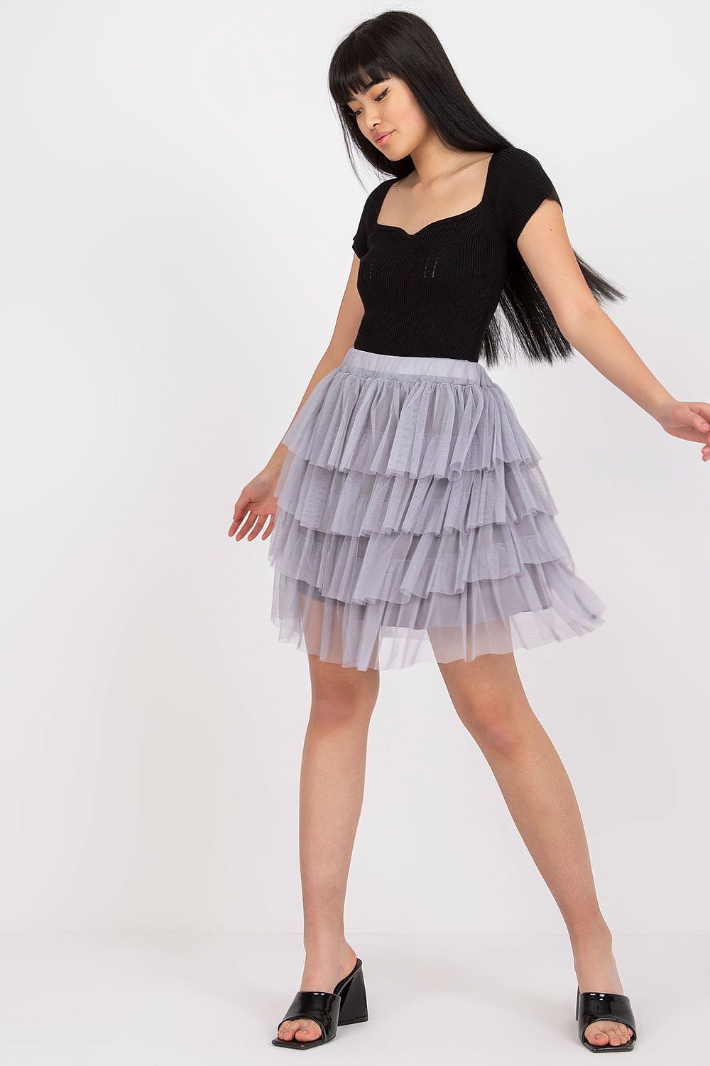 The luxurious mini tulle skirt with frills by Och Bella styled for a sophisticated evening look, perfect for any elegant event.
