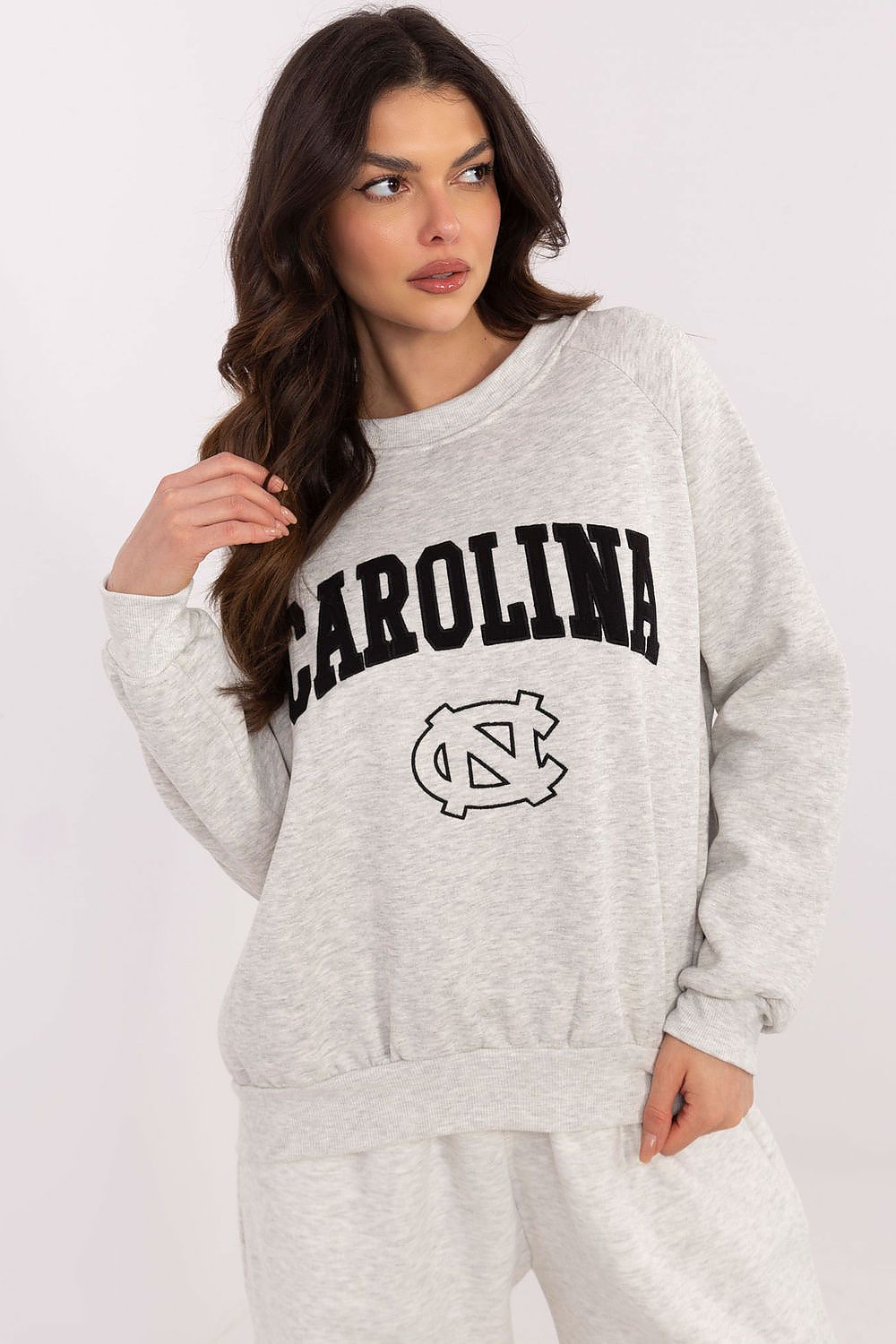 Relaxed lifestyle image of luxury women's casual sweatshirt by Factory Price worn with jeans, showcasing its stylish and comfortable design.