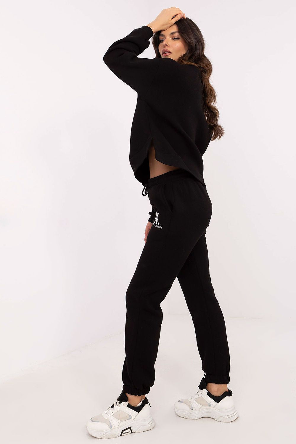 Model wearing the Factory Price cotton-polyester hoodie and pants set in casual setting, illustrating versatility and comfort for daily activities.