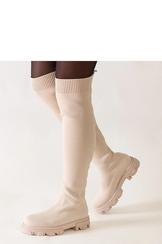 Luxurious beige long heel boots by Solea, featuring a comfortable slip-on closure and robust rubber sole for optimal grip.