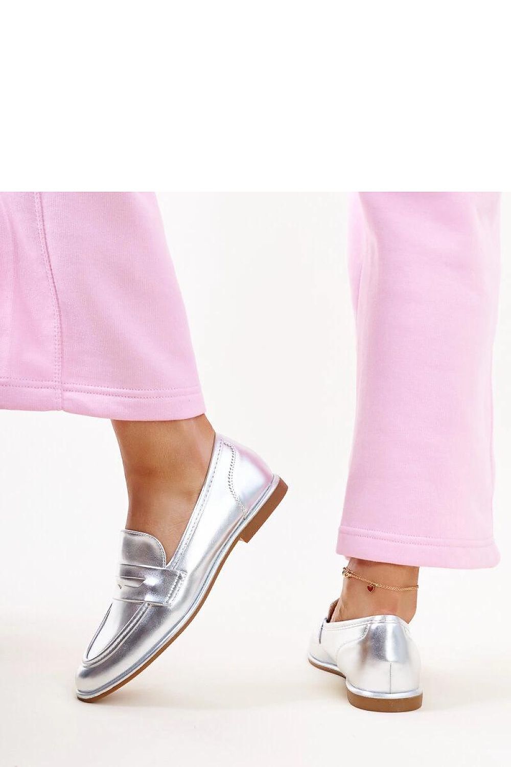 Lifestyle shot of wearing Solea silver moccasins Nasia, combining luxury fashion with effortless style in eco-friendly materials for an enviable look.