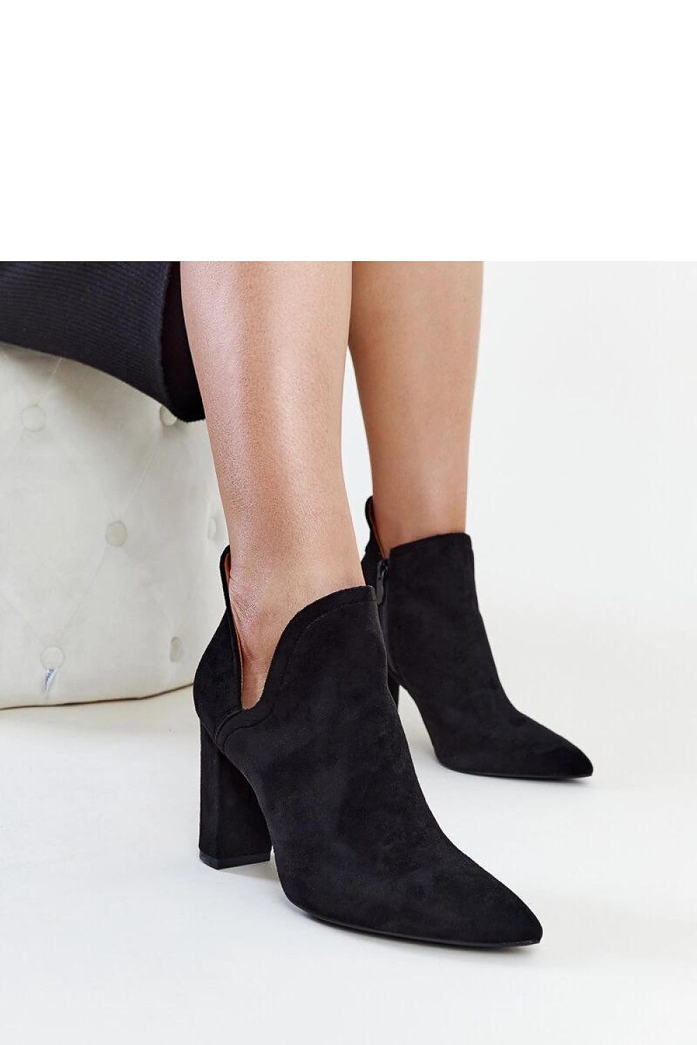 Luxurious Solea black asymmetric ankle boots with an 8.5cm heel, featuring a sleek zipper closure for easy wear. Perfect for modern elegance.