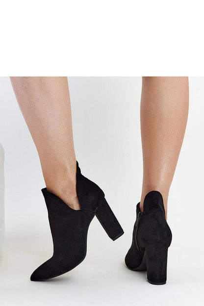 Solea exquisite black ankle boots with an innovative asymmetrical design, crafted from high-quality synthetic leather for a contemporary luxury look.