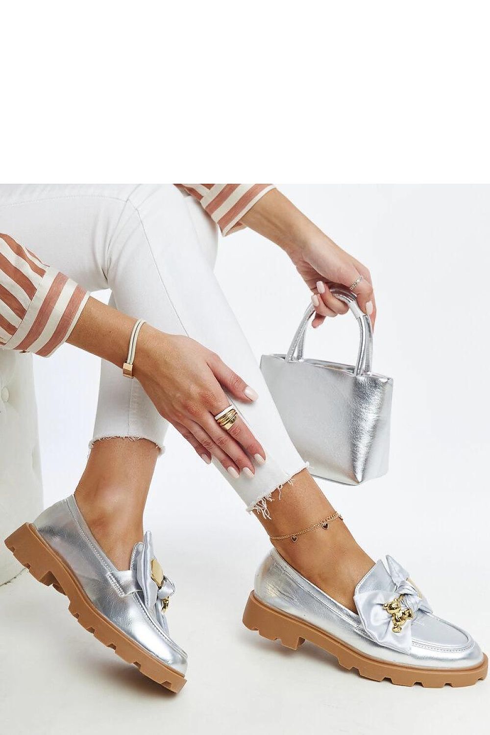 Chic and comfortable Solea Silver Moccasins slip-on shoes with a metallic sheen and decorative buckle, designed for luxury and modern fashion.