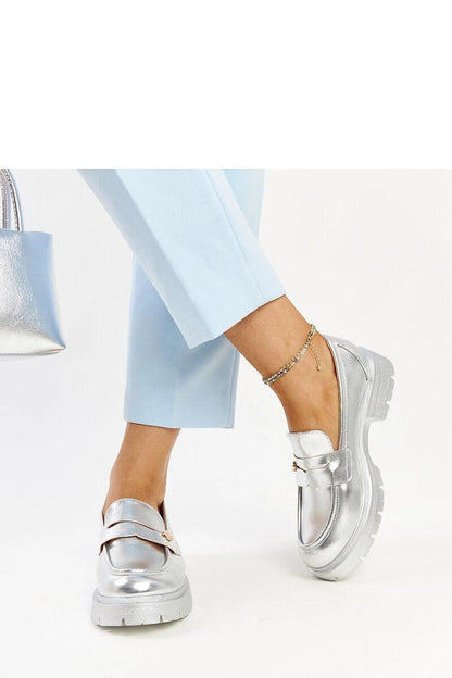 A stylish pair of Solea dark green Eko leather moccasins displayed, highlighting their sleek rounded toe and fashionable design.