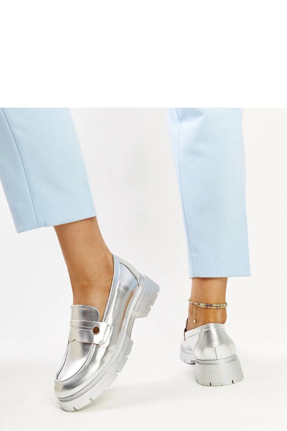 Solea dark green slip-on moccasins on a soft surface, demonstrating luxury and comfort, ideal for everyday wear.