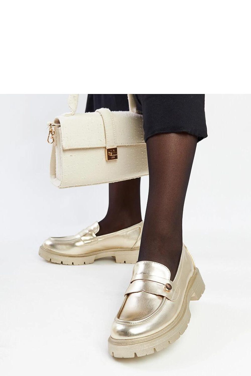 Stylish lifestyle shot of Solea dark green moccasins paired with chic outfits, demonstrating their versatility for spring and summer ensembles.