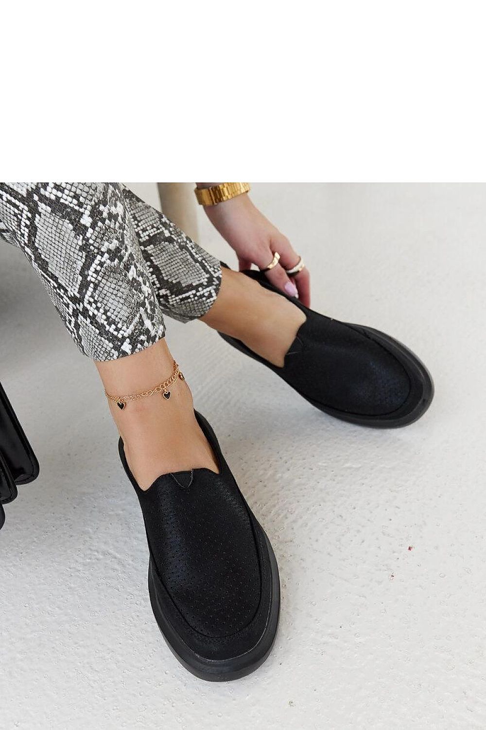 Close-up of Solea Marta black metallic slip-on shoes, featuring flexible rubber construction and sophisticated eco leather, ensuring style and comfort.