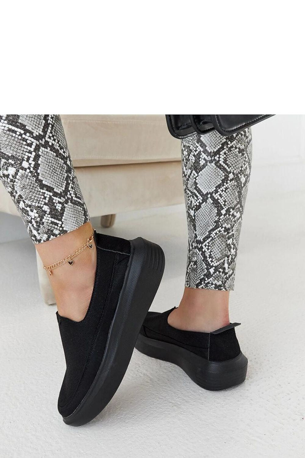 Elegant portrayal of Solea Marta black metallic rubber slip-on shoes, emphasising comfort, style, and eco-friendly craftsmanship for seasonal wear.