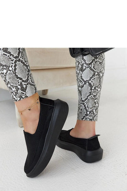 Elegant portrayal of Solea Marta black metallic rubber slip-on shoes, emphasising comfort, style, and eco-friendly craftsmanship for seasonal wear.