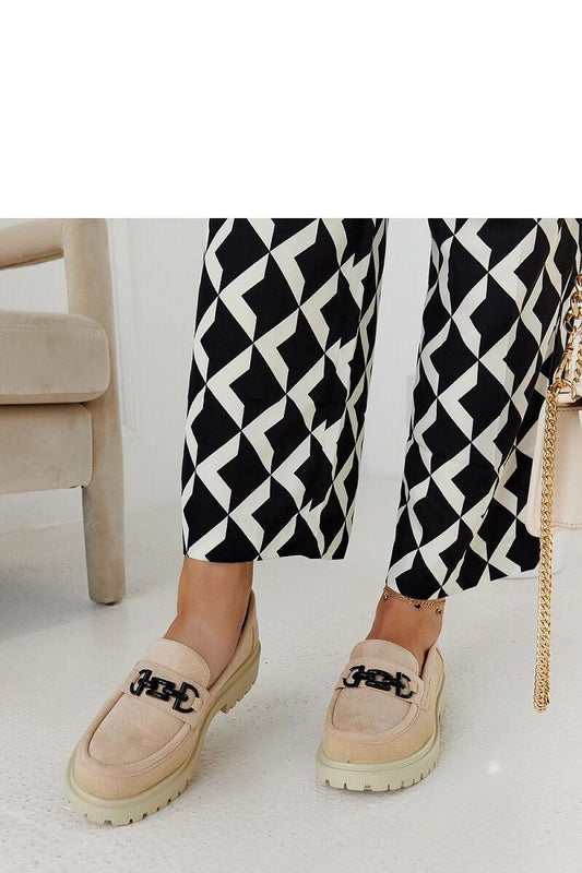 Close-up of Solea creamy suede moccasins with an exquisite buckle detail, reflecting luxury and sophistication ideal for summer outings.