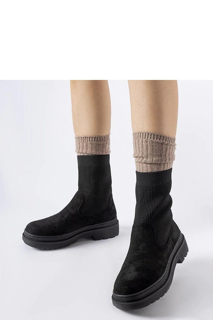 Solea Hawkins black chunky boots featuring a sock-like design, high ankle cut, and round toe, reflecting luxury style and comfort.