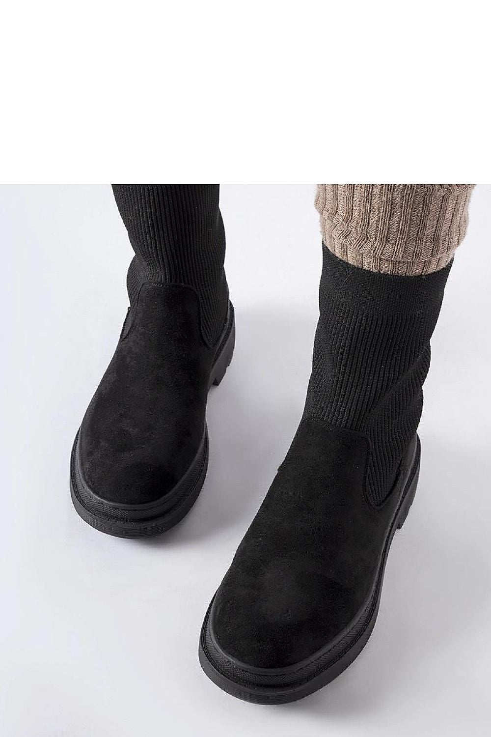 Elegant Solea Hawkins black sock-like chunky boots, showcasing their versatility for both casual and formal outfits with a sleek and sophisticated appearance.